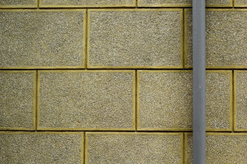 a close up of a street sign on a brick wall