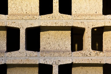 A close up of a brick wall with holes in it