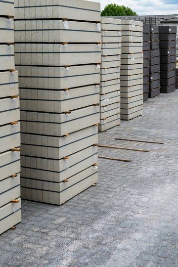 Piles of concrete paving stones are stacked neatly