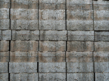 A stack of weathered grey concrete blocks.